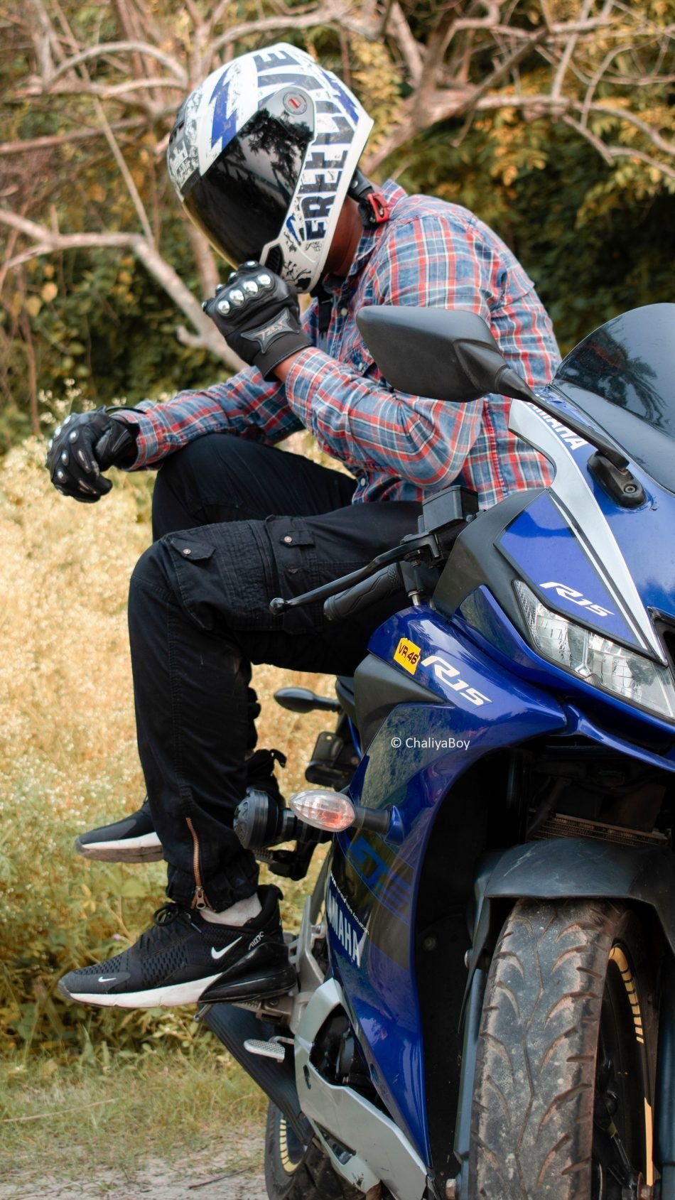 Premium Photo | Fashionable male motorcycle driver poses on black motorbike,  wears protective sunglasses